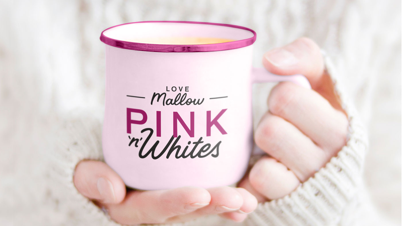 An image of the a woman holding a mug of tea with the new Pink & Whites logo printed on the mug
