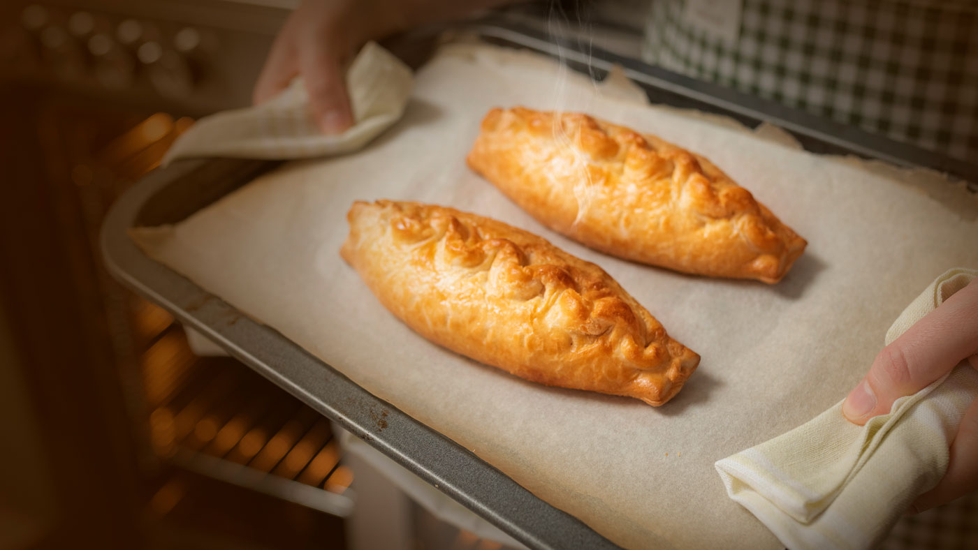 An image of cooked pasties on an oven tray