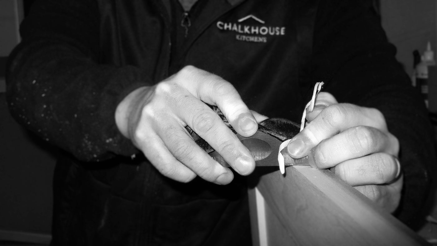 Closeup of Chalkhouse craftsman using a hand plane