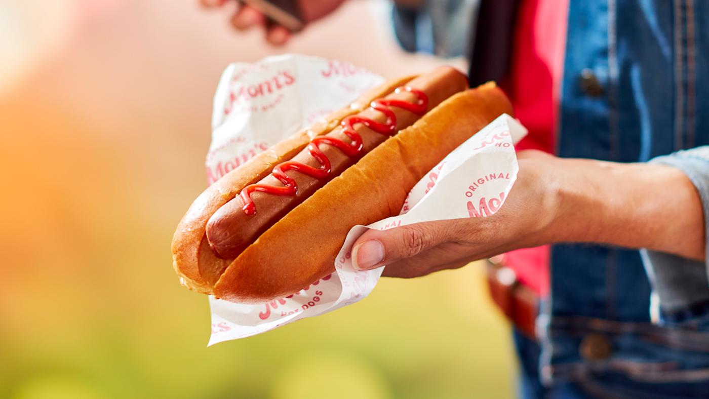 Image of woman holding hot dog